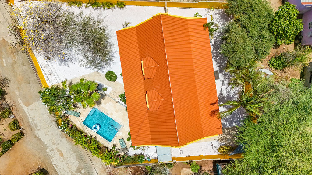 Top-down aerial of the villa rooftop and pool deck