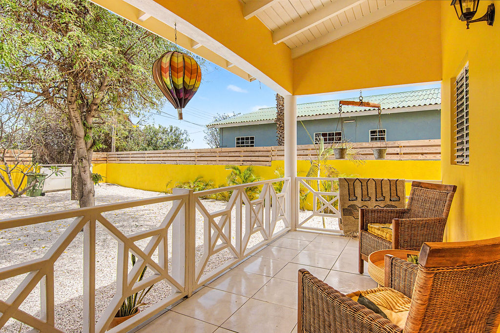 Front porch with rattan chairs and garden view